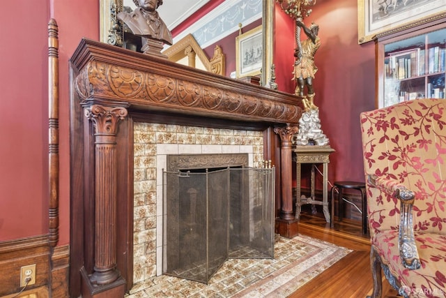 interior details featuring wood finished floors and a tile fireplace