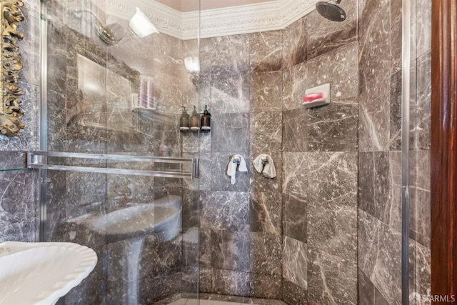 bathroom featuring a shower with door and ornamental molding