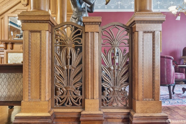 details featuring a gate and wallpapered walls