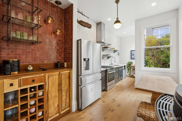 837 Union St, San Francisco, CA 94133 - kitchen with stainless steel appliances, tasteful backsplash, wall chimney range hood, light wood-type flooring, and open shelves