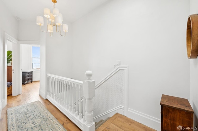 837 Union St, San Francisco, CA 94133 - hall featuring light wood finished floors, a chandelier, an upstairs landing, and baseboards