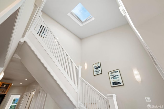 stairs with a skylight