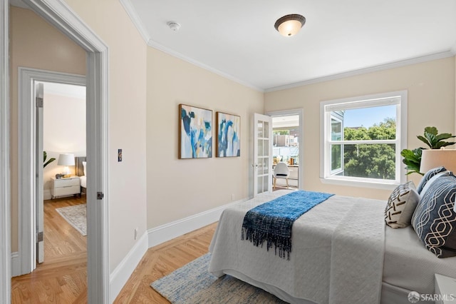 bedroom featuring crown molding, light hardwood / wood-style flooring, and french doors