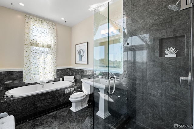 bathroom featuring shower with separate bathtub, tile walls, and toilet