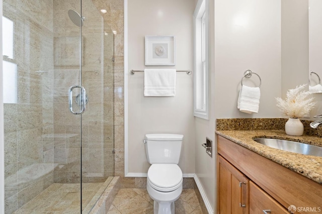 bathroom with vanity, tile patterned flooring, a shower with shower door, and toilet