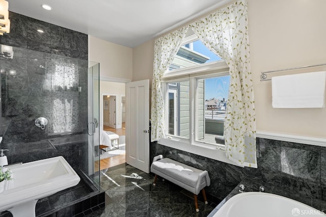 bathroom featuring tile walls and a washtub