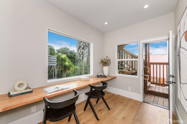 office area featuring light hardwood / wood-style flooring and a healthy amount of sunlight