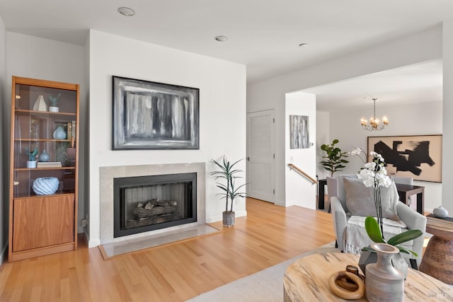 living room featuring wood-type flooring and a notable chandelier