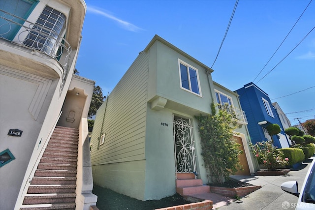 1675 Quint St, San Francisco, CA 94124 - view of property exterior featuring stairs, stucco siding, and entry steps