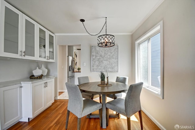 1675 Quint St, San Francisco, CA 94124 - dining room with a chandelier, crown molding, baseboards, wood finished floors, and plenty of natural light