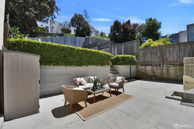 1675 Quint St, San Francisco, CA 94124 - fenced backyard featuring a patio, an outdoor hangout area, and a residential view