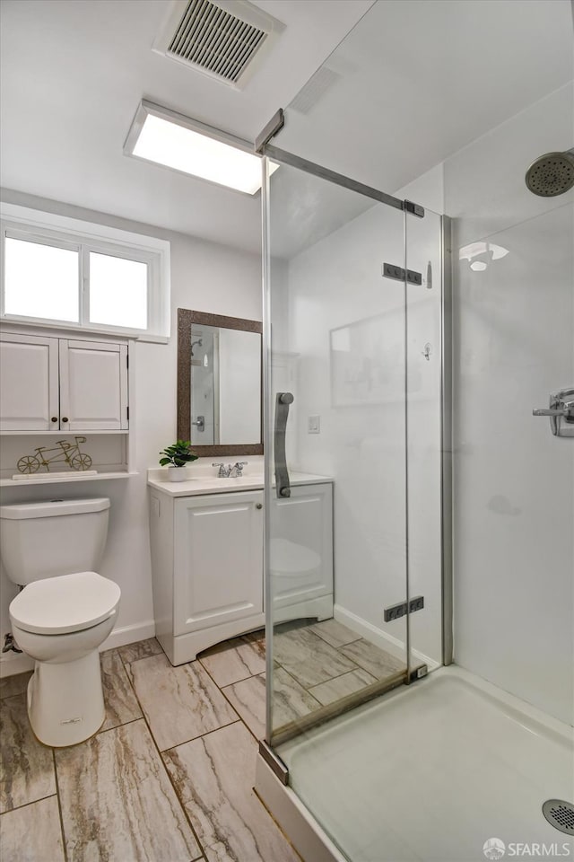 1675 Quint St, San Francisco, CA 94124 - bathroom featuring toilet, a stall shower, vanity, marble finish flooring, and baseboards