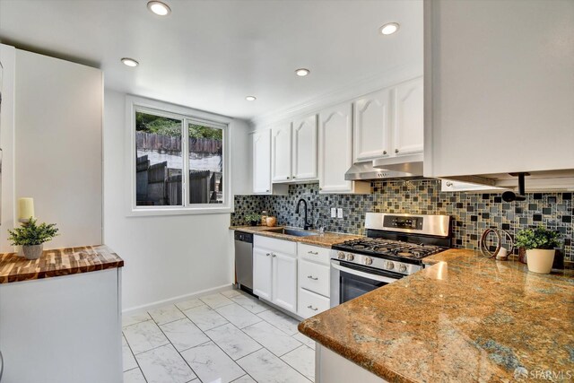 1675 Quint St, San Francisco, CA 94124 - kitchen with a sink, stainless steel appliances, under cabinet range hood, white cabinetry, and recessed lighting