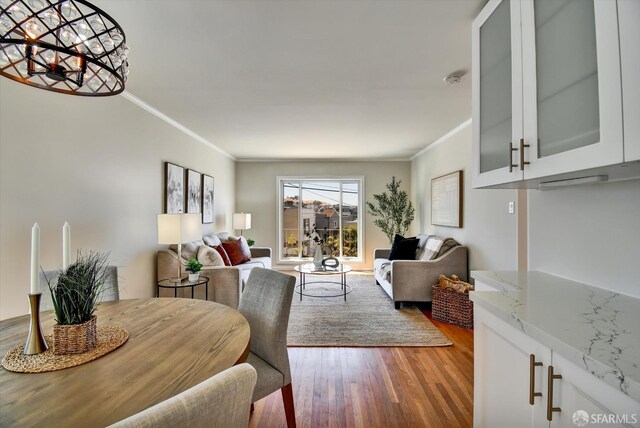 1675 Quint St, San Francisco, CA 94124 - living area with crown molding, wood finished floors, and a chandelier