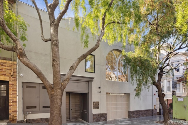 view of front of house with a garage and stucco siding