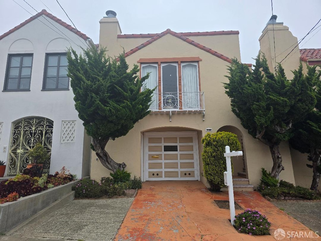 2124 18th Ave, San Francisco, CA 94116 - view of front of house with stucco siding, a balcony, a chimney, and an attached garage