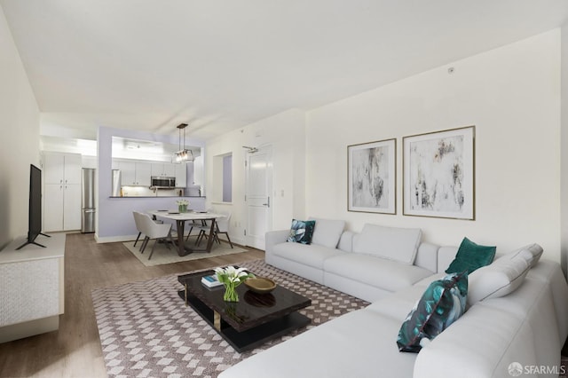 living room featuring light hardwood / wood-style floors and a notable chandelier