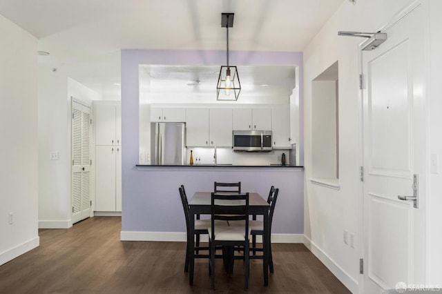 dining room with dark hardwood / wood-style floors