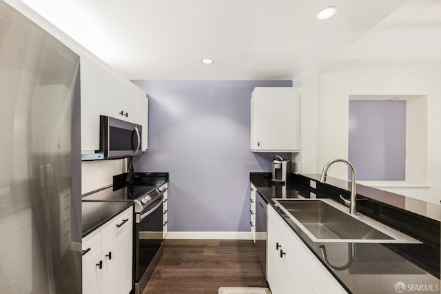 kitchen with stainless steel appliances, white cabinetry, dark hardwood / wood-style floors, and sink