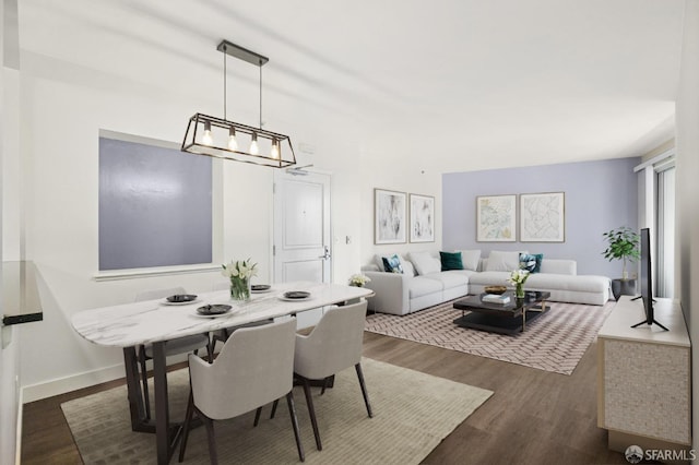 dining space featuring dark hardwood / wood-style floors and a chandelier