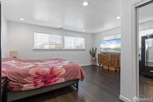 bedroom with dark wood-type flooring