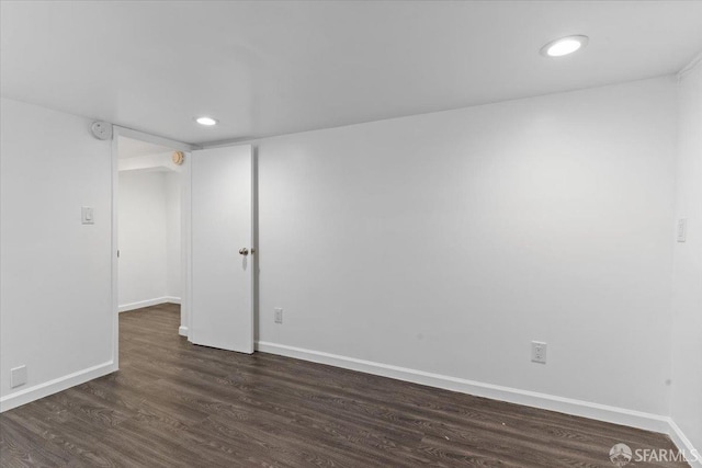 empty room with dark hardwood / wood-style floors
