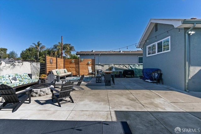 view of patio / terrace featuring an outdoor living space with a fire pit