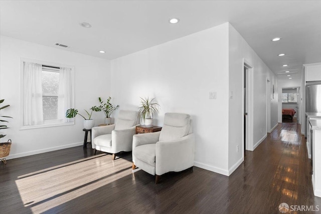 sitting room with dark hardwood / wood-style flooring