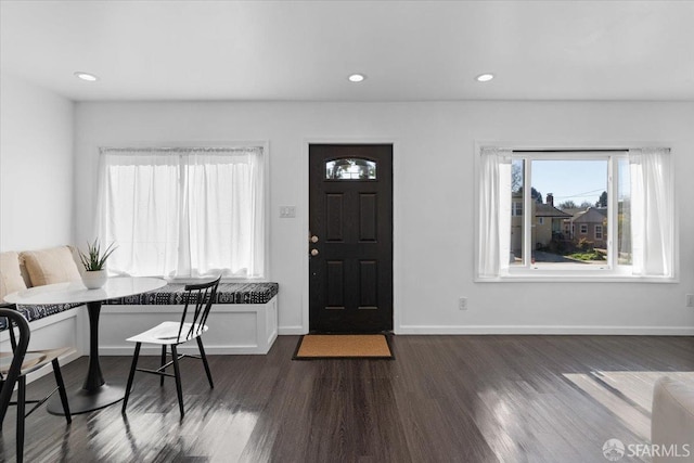 foyer entrance featuring breakfast area and dark hardwood / wood-style floors