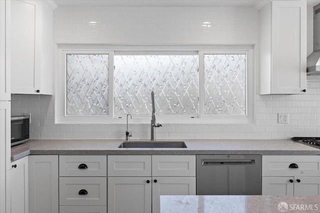 kitchen featuring white cabinetry, sink, tasteful backsplash, and appliances with stainless steel finishes
