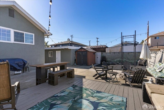 wooden terrace featuring a storage shed