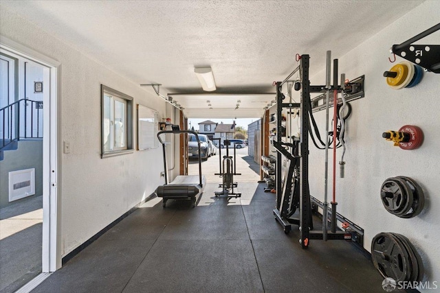 workout area with a textured ceiling