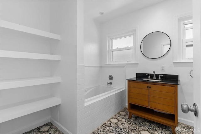 bathroom with vanity and tiled bath