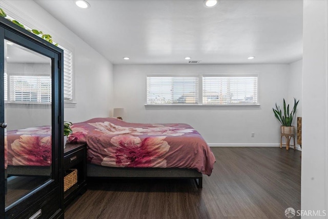 bedroom with dark hardwood / wood-style flooring
