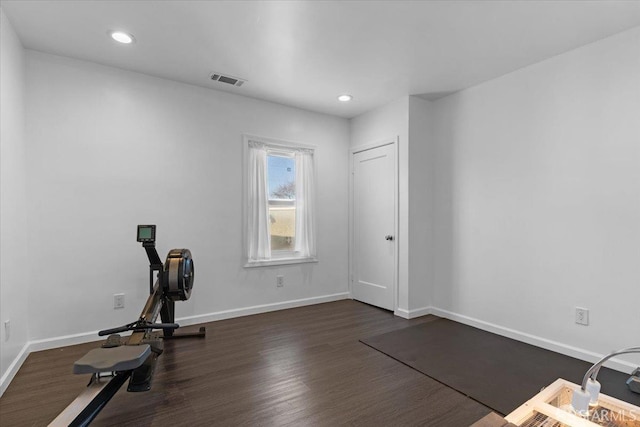 exercise area featuring dark wood-type flooring