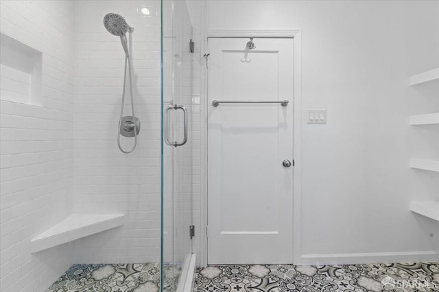 bathroom featuring a shower with door and tile patterned flooring