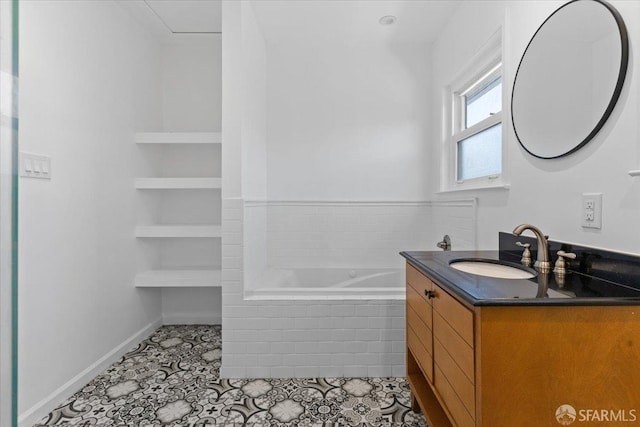 bathroom featuring tile patterned floors, vanity, built in features, and tiled tub