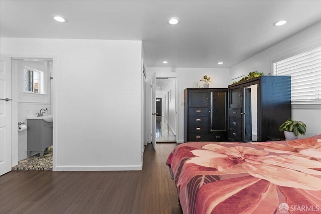 bedroom featuring multiple windows and dark wood-type flooring