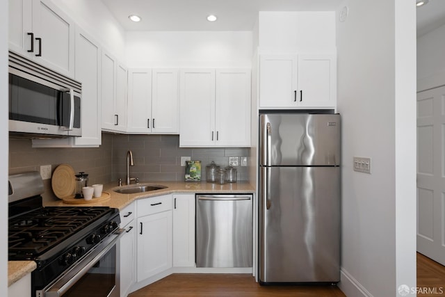 1141 Church St, San Francisco, CA 94114 - kitchen featuring stainless steel appliances, a sink, decorative backsplash, white cabinets, and recessed lighting