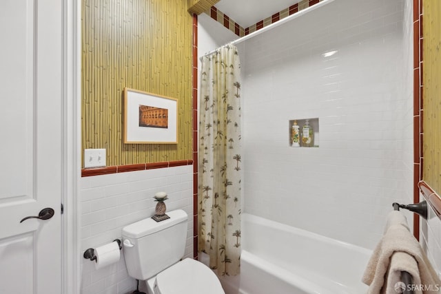 bathroom featuring tile walls, shower / tub combo with curtain, and toilet