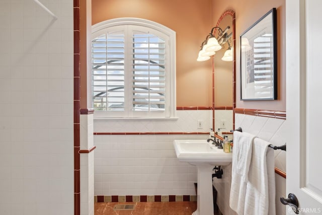 bathroom with tile walls