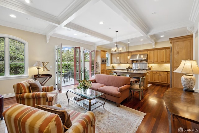 living room with dark hardwood / wood-style flooring, ornamental molding, a chandelier, and beamed ceiling