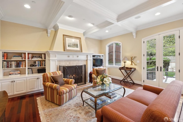 living room featuring a tile fireplace, hardwood / wood-style flooring, coffered ceiling, beam ceiling, and french doors