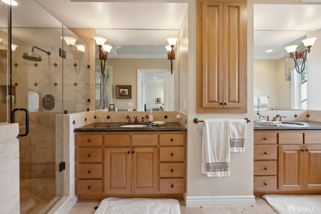 bathroom with vanity, crown molding, and a shower with shower door