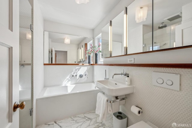 bathroom with visible vents, a shower stall, a bath, marble finish floor, and a sink