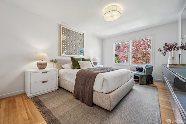 bedroom featuring light wood-style flooring and baseboards