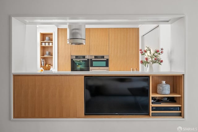 kitchen featuring modern cabinets, oven, and light countertops