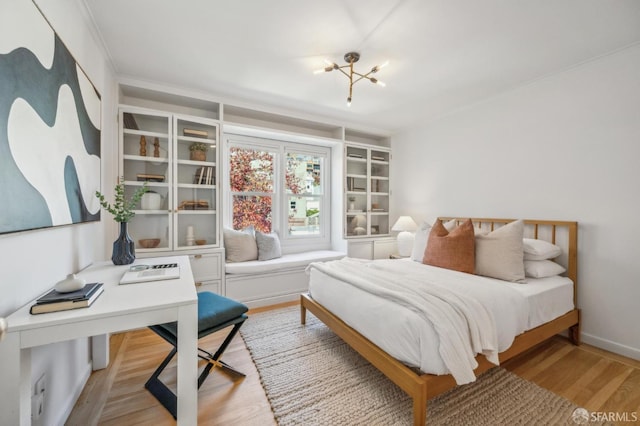 bedroom with wood finished floors and baseboards