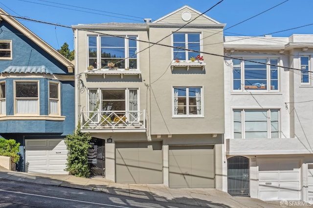 view of property with stucco siding and an attached garage