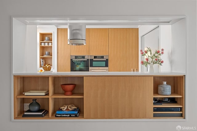 kitchen with double oven, open shelves, built in shelves, and modern cabinets